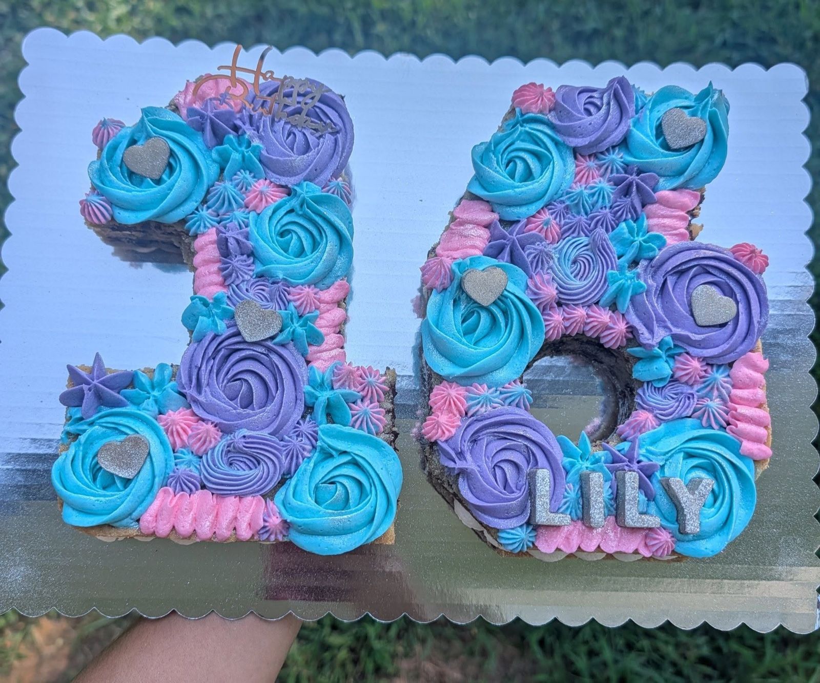 Number 16 cookie cake with blue, pink and teal rosettes